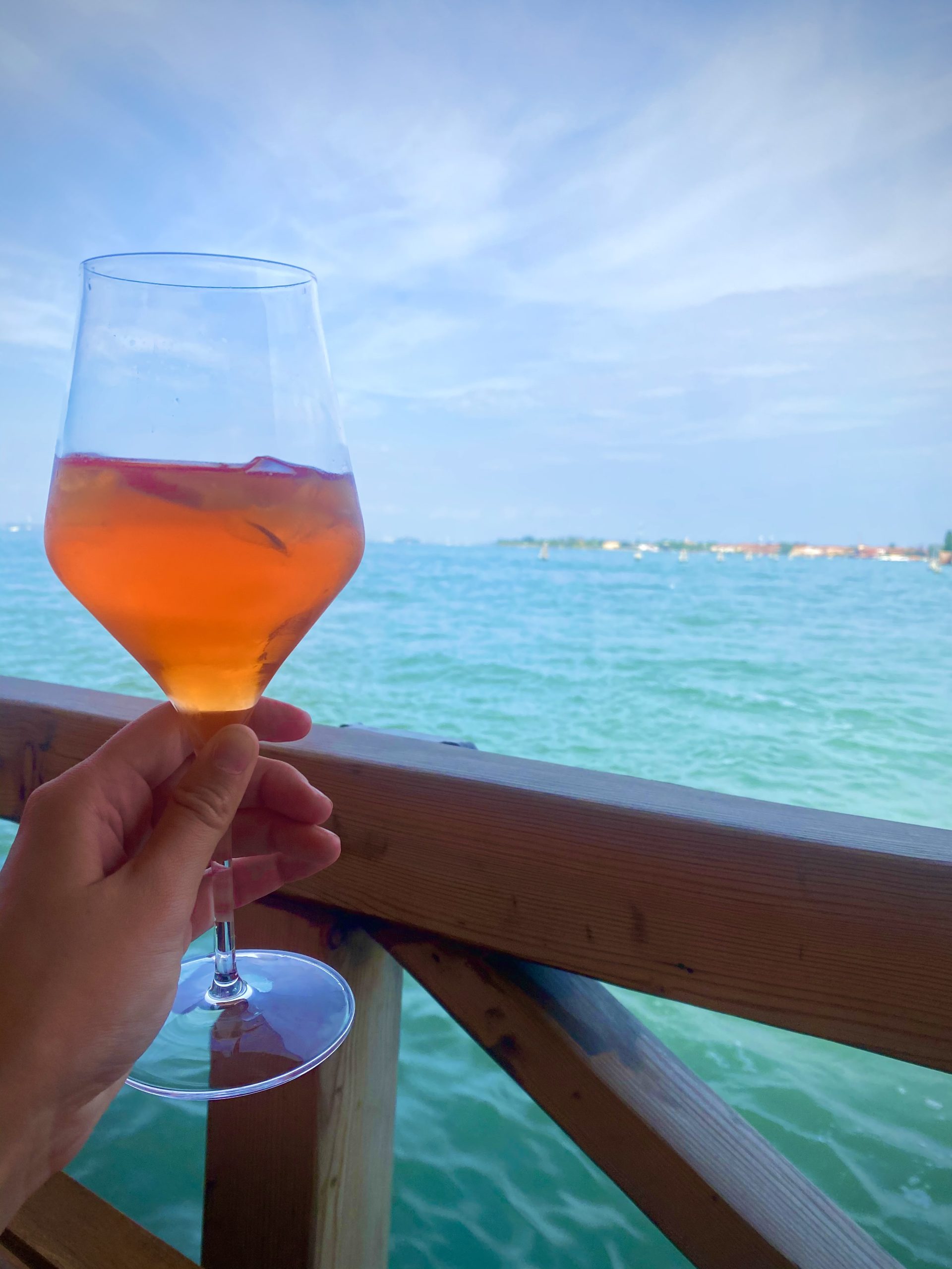 Woman Holding A Spritz On The Waterway in Venice